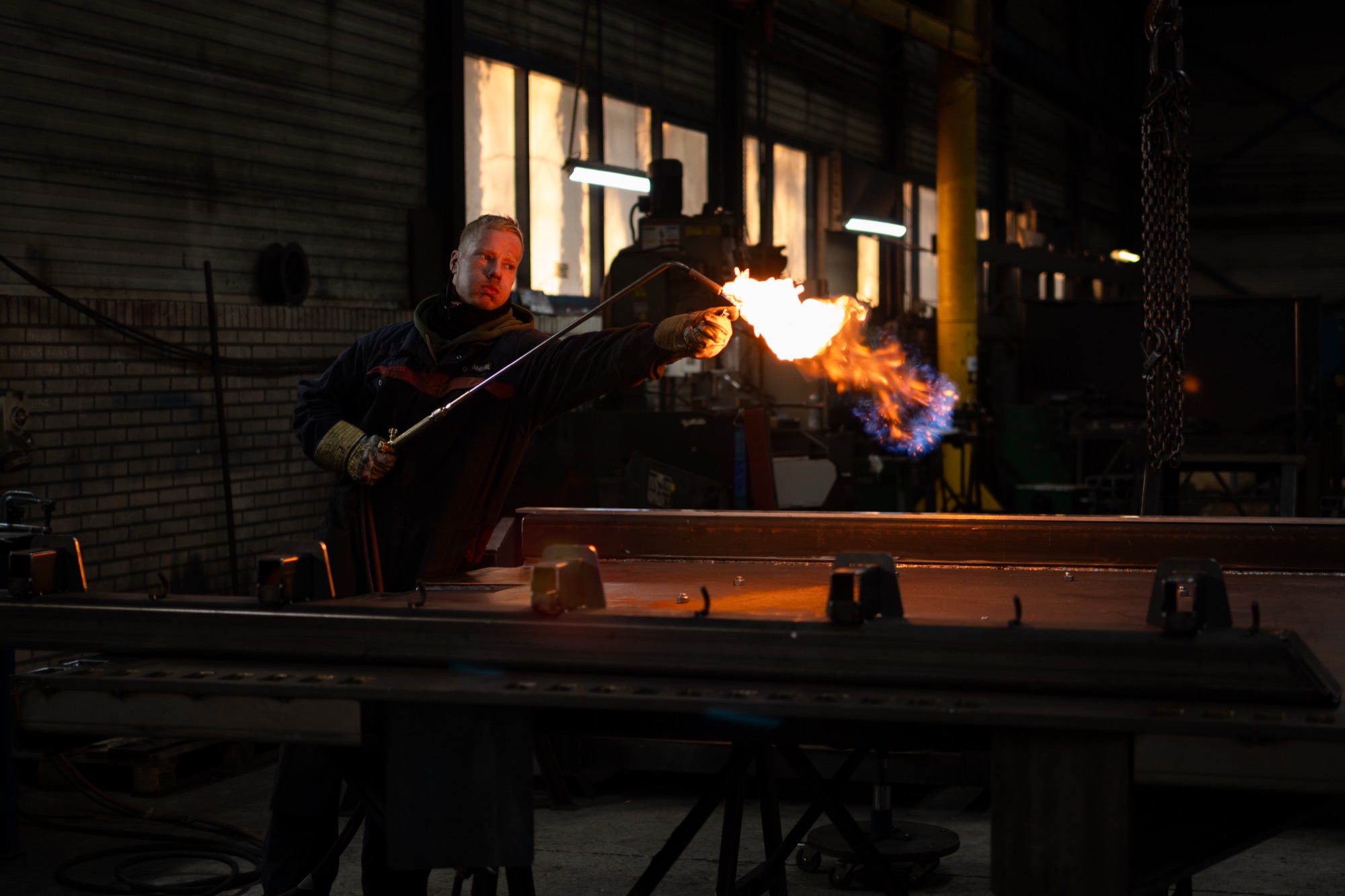Medewerker van GS Meppel werkt met een snijbrander aan een stalen balk